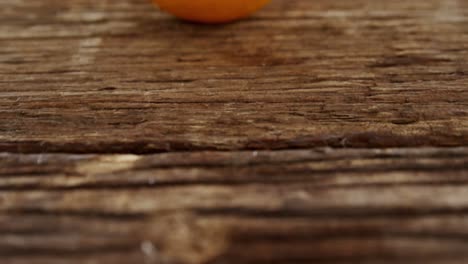 half peeled sweet lime on wooden plank