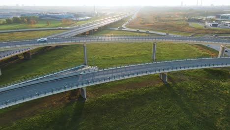 an aerial view of a country highway with bridges on which cars drive in the sunny evening no traffic