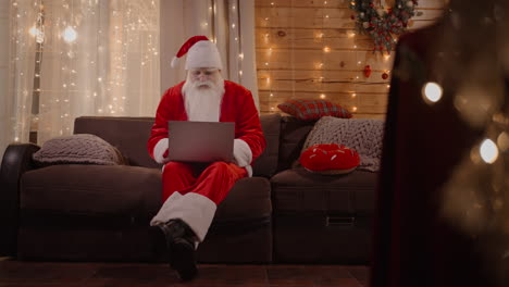 santa responds to emails browses the internet bank and works on a laptop