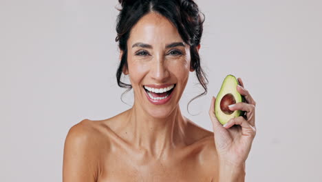 woman holding an avocado