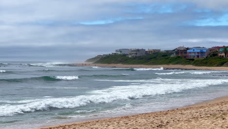 surfistas de verano jbay jefferys bay sudáfrica olas de surf súper imposibles boneyard wsl corona olas abiertas chocando en la playa cámara lenta panorámica a la derecha
