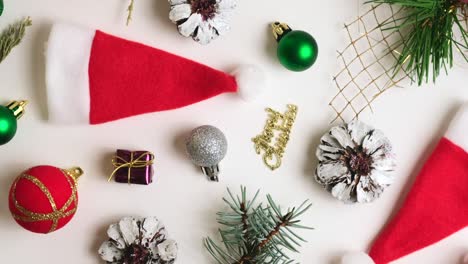 christmas composition with new year decorations, balls, stars, tree, santa hat, spruce branches and sweets