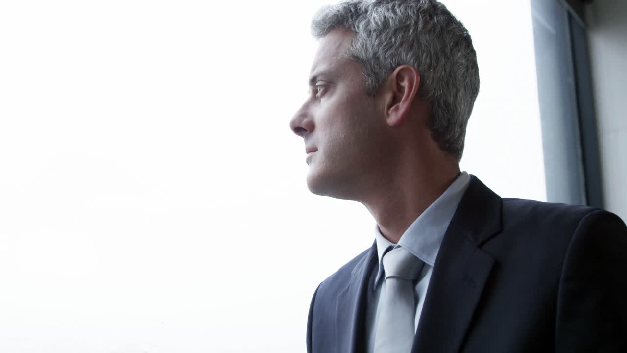 Thoughtful businessman looks away