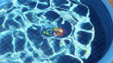 rainbow diving mask in a kiddie pool