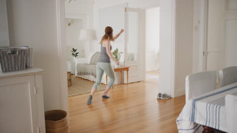 happy-young-woman-dancing-at-home-sliding-on-floor-celebrating-on-weekend-with-funky-dance-moves-having-fun-4k