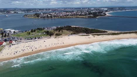 aerial view of a beautiful beach and a river bend with a town in the background