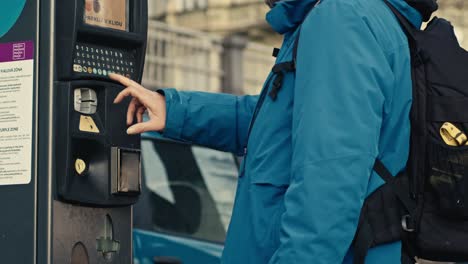 man paying ticket, parking machine on street in prague, easy way to park anywhere