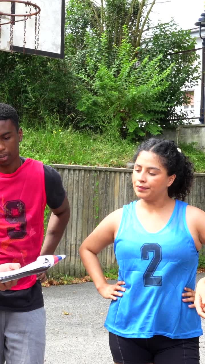 Basketball Team Reviewing Plays Outdoors