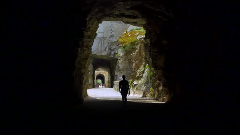 abandoned train tunnels, woman walks from dark into light, 1800s railroad