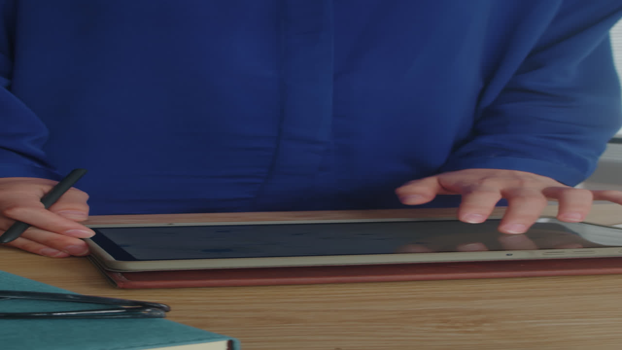 Vertical of Analyst Working on Report Using Digital Tablet