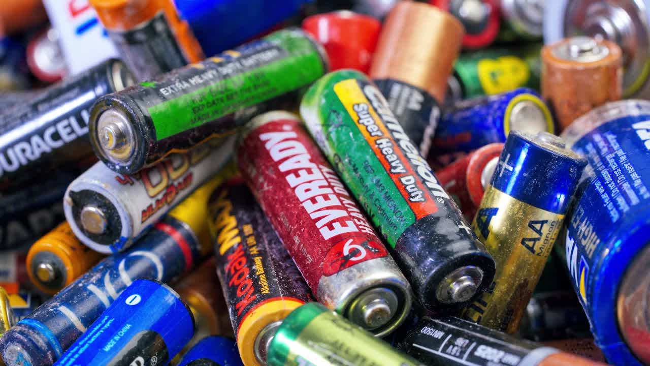 A Lot Of Used Alkaline Batteries For Recycling. Waste, collection and recycling, high danger for the environment