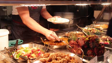 hand serving food at melbourne market stall