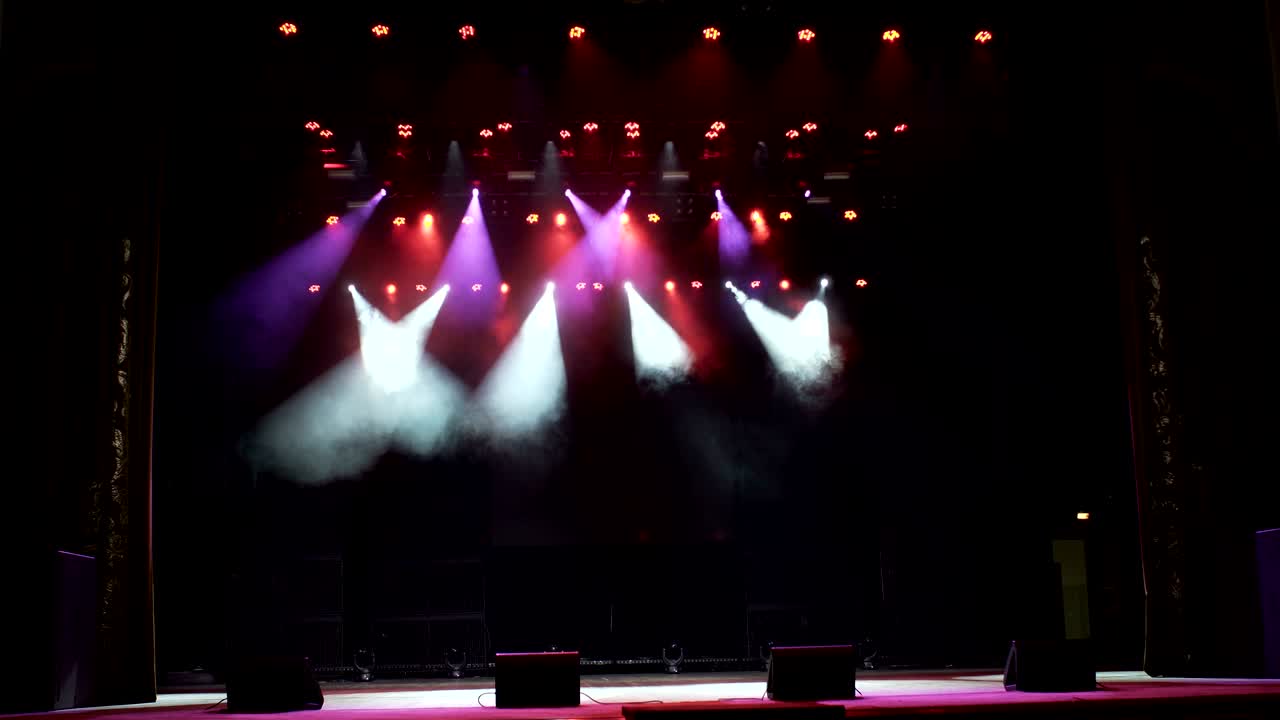 Stage lights. Several projectors in the dark.