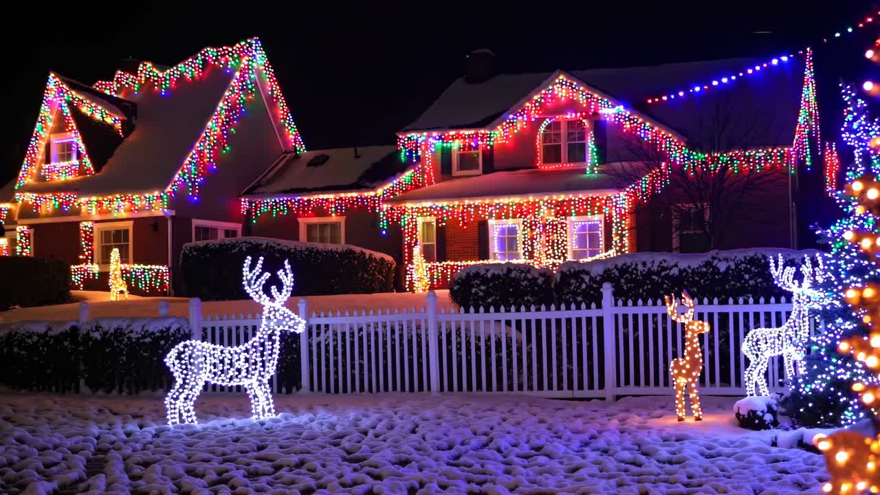 Festive houses adorned with colorful Christmas lights, captured from a low angle