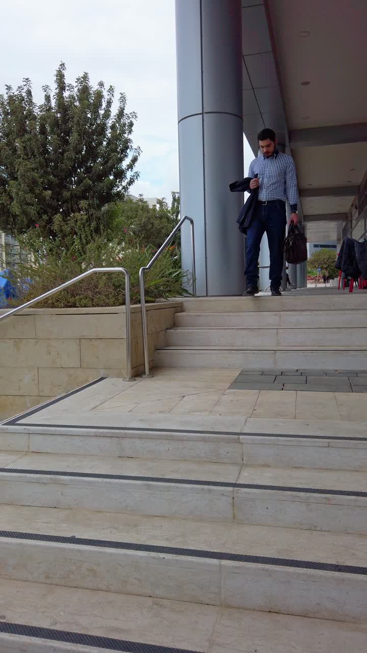 Businessman leaving the entrance to an office building