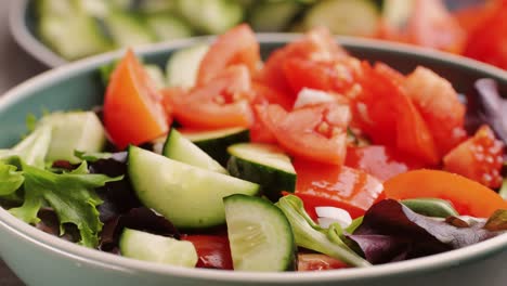 mixed greens salad with cucumber, tomatoes, and onion
