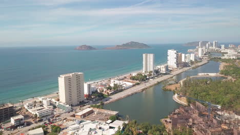 Aerial-overview-of-beautiful-Mexican-city-near-ocean-in-summer