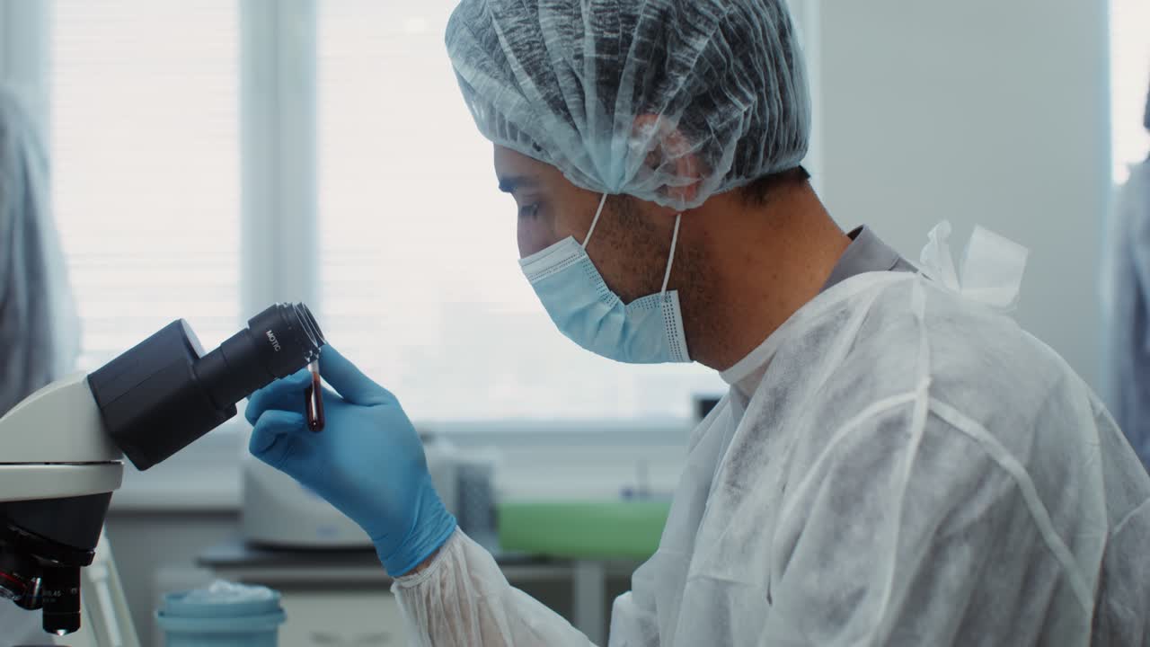 Scientist Examining Blood Sample in Laboratory