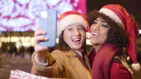 two women taking a christmas selfie