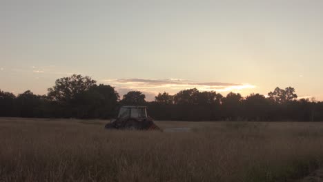 tractor in sunset field panning shot