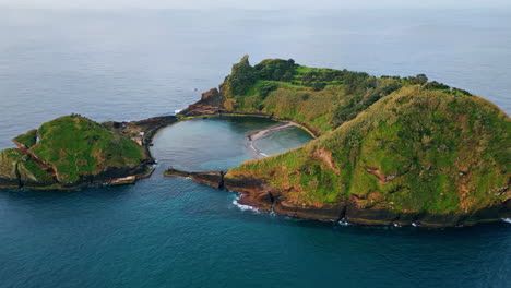 aerial amazing green island washing by calm dark ocean. relaxing nature scenery.