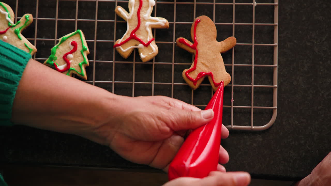Decorating festive cookies with colorful icing for Christmas celebration at home