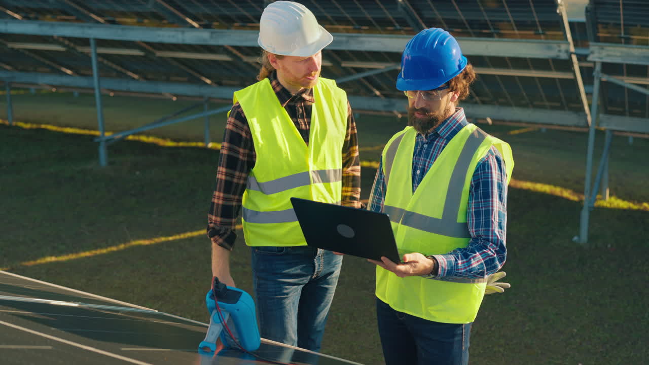 Engineers Inspecting Solar Panels at a Solar Farm