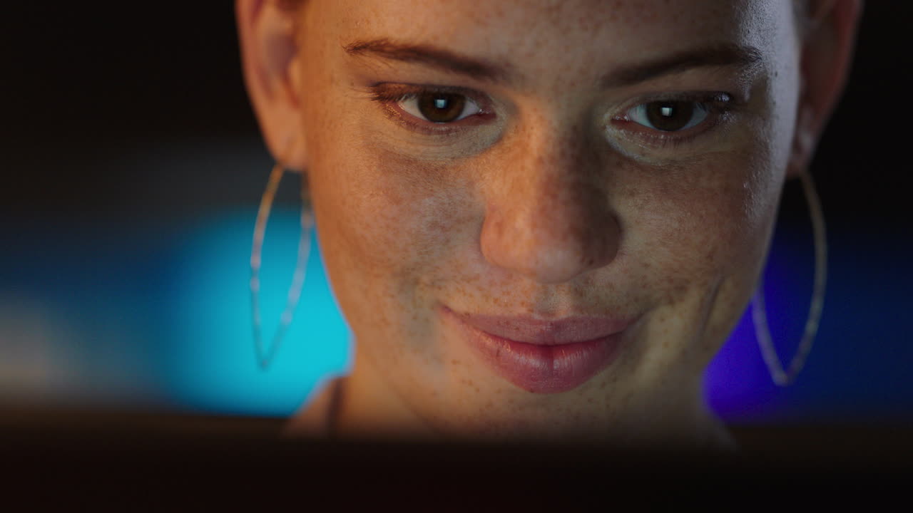 close up portrait beautiful woman using tablet computer smiling enjoying browsing internet looking at screen working late