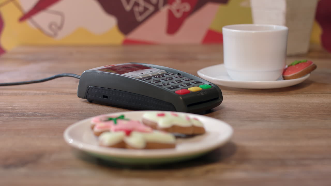 Woman hand swipe credit card in payment terminal. Woman paying by credit card