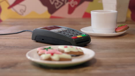 woman hand swipe credit card in payment terminal. woman paying by credit card