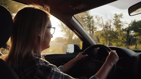 Attractive-Middle-Aged-Woman-Driving-A-Car-In-The-American-Suburbs