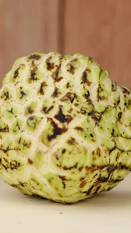 custard apple rotates on a wooden surface