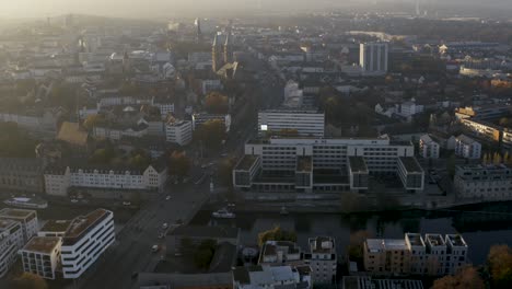 Drone-shot-of-the-cityscape-landscape-of-Kassel-in-beautiuful-soft-sunlight-and-covered-in-fog