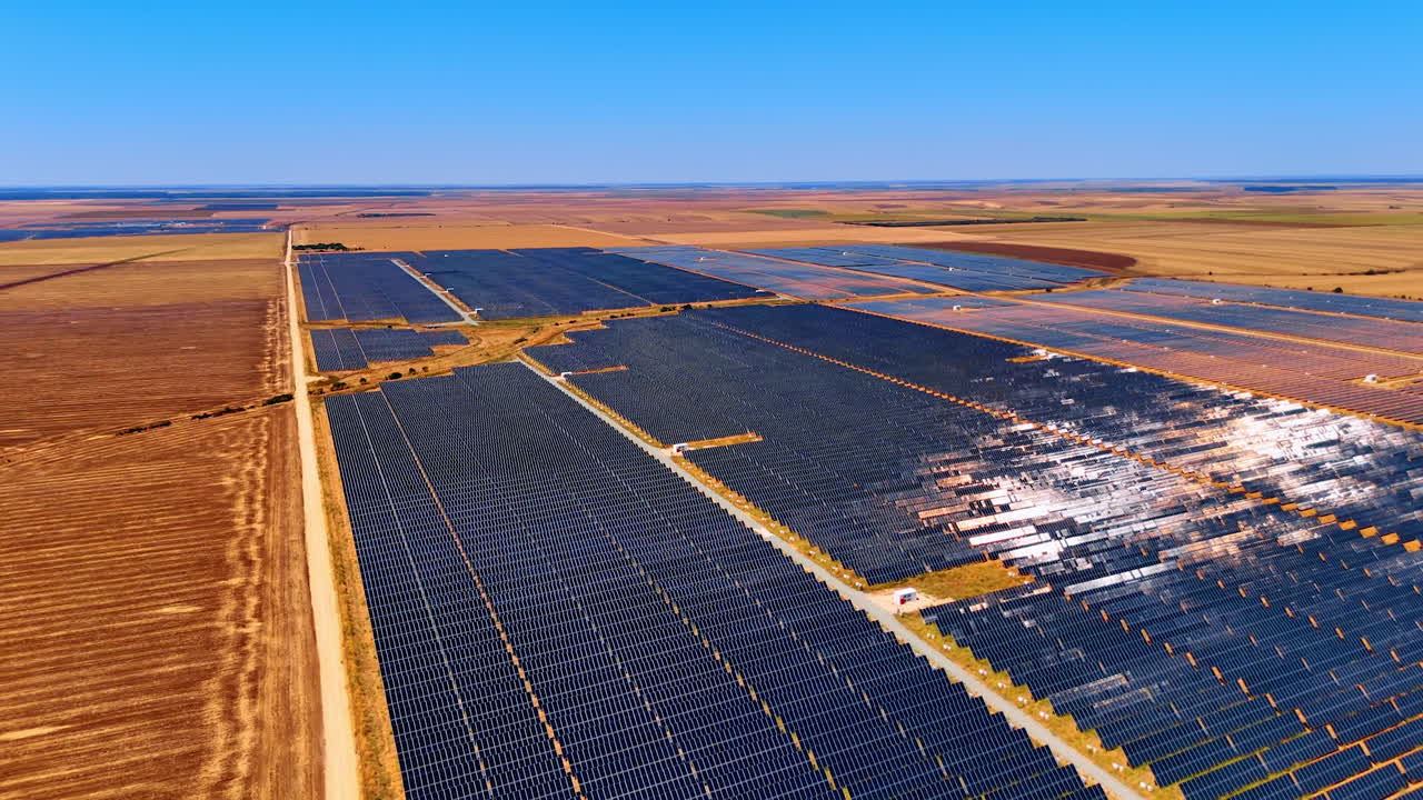 Footage over the countryside used for energy production. Modern solar panels generate renewable energy