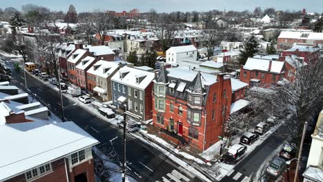 Aerial-approaching-shot-of-snowy-housing-area-on-Main-street-in-winter