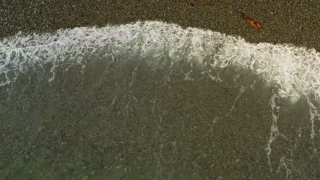 close up of ocean waves from a top down view over a coastal beach in looc bay, philippines