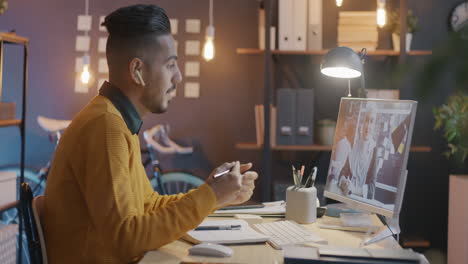 man having a video call in his home office