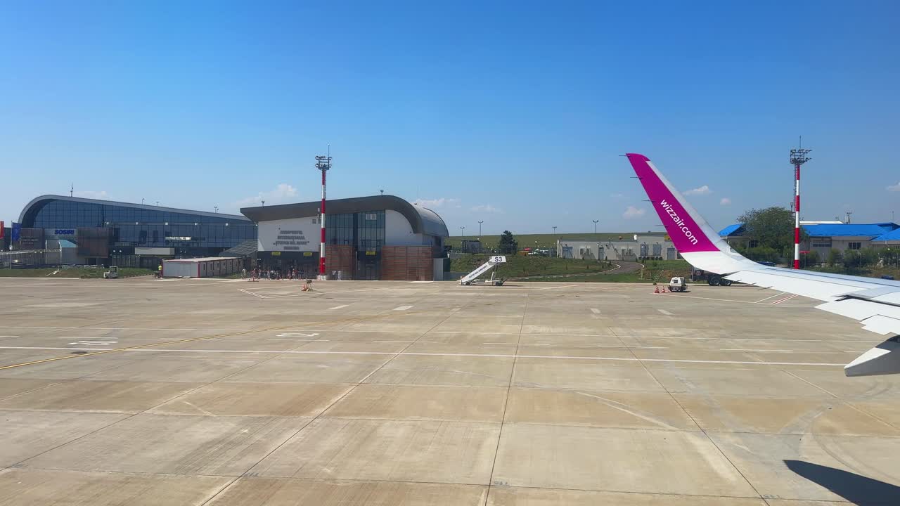 Plane window view takeoff Suceava Airport in Romania, fly airplane wing view