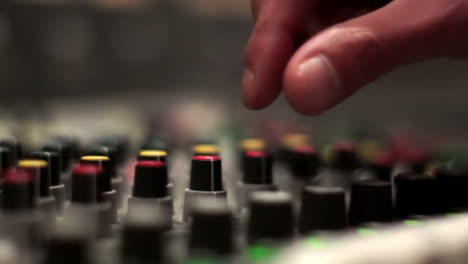 sound engineer adjusting audio mixer