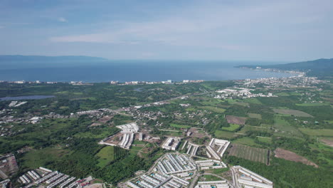 Frontal-drone-flight-showcasing-the-hotel-lined-coast-of-Banderas-Bay-and-Nuevo-Vallarta,-with-a-full-bay-view