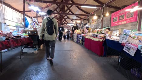 shoppers browsing stalls in a busy market