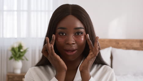 woman applying eye patches