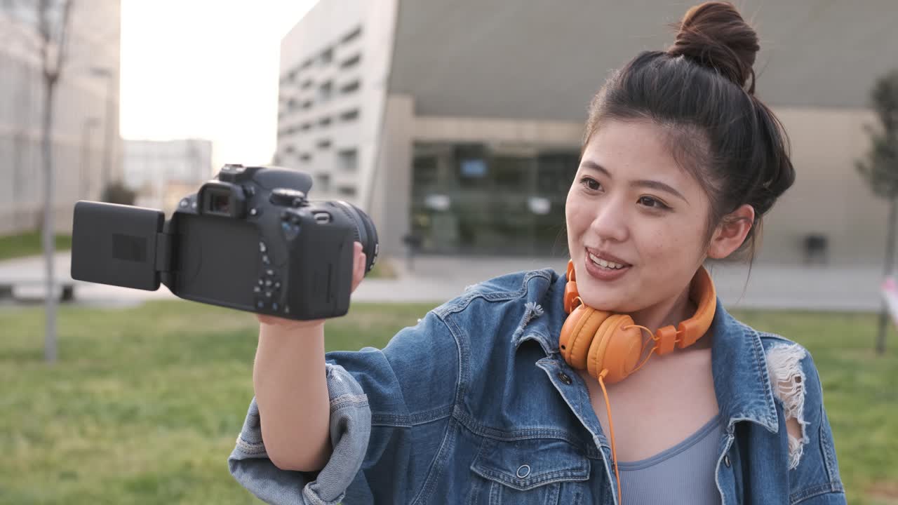 Asian woman vlogging and using camera, social media influencer content creator lifestyle