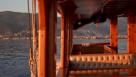 wooden boat with city and mountain view at sunset/sunrise