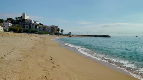 Platja-de-les-Barques-sea-field-Maresme-Barcelona-Mediterranean-coast-plane-close-to-turquoise-blue-transparent-water-beach-without-people