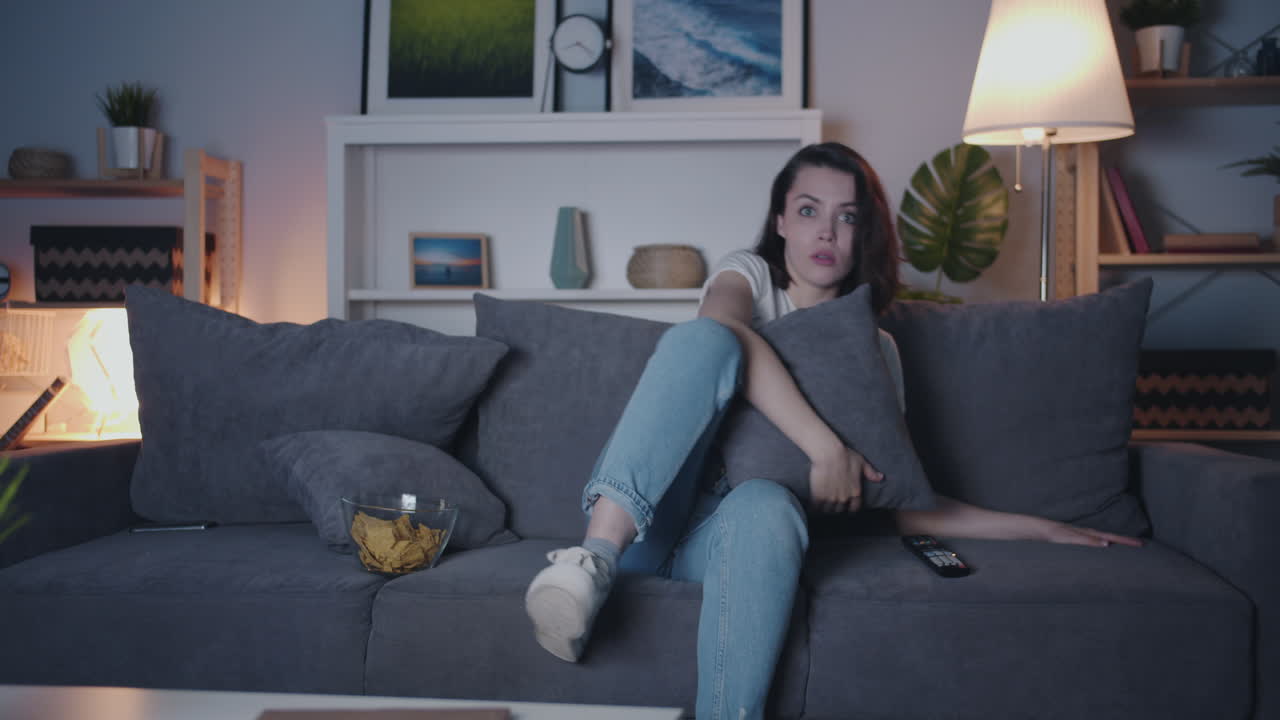 Woman watching a movie at home