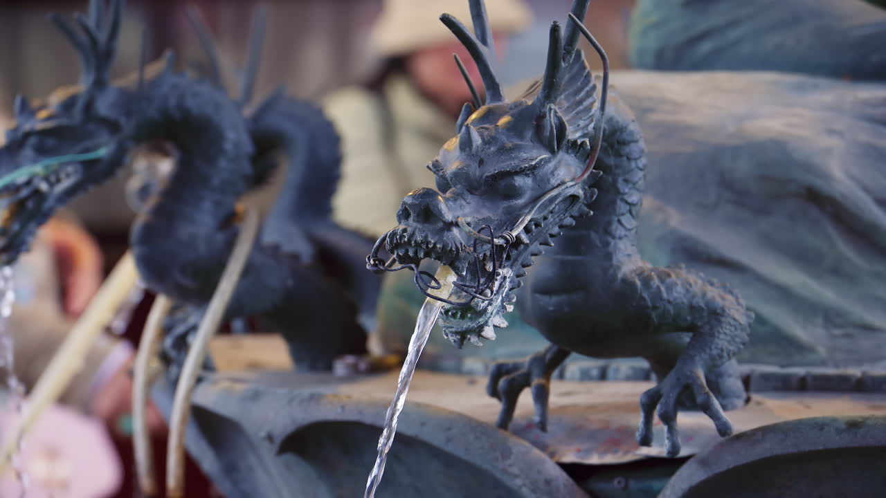 Close up of a dragon purification water fountain at the Senso-ji temple in daylight in Tokyo, Japan