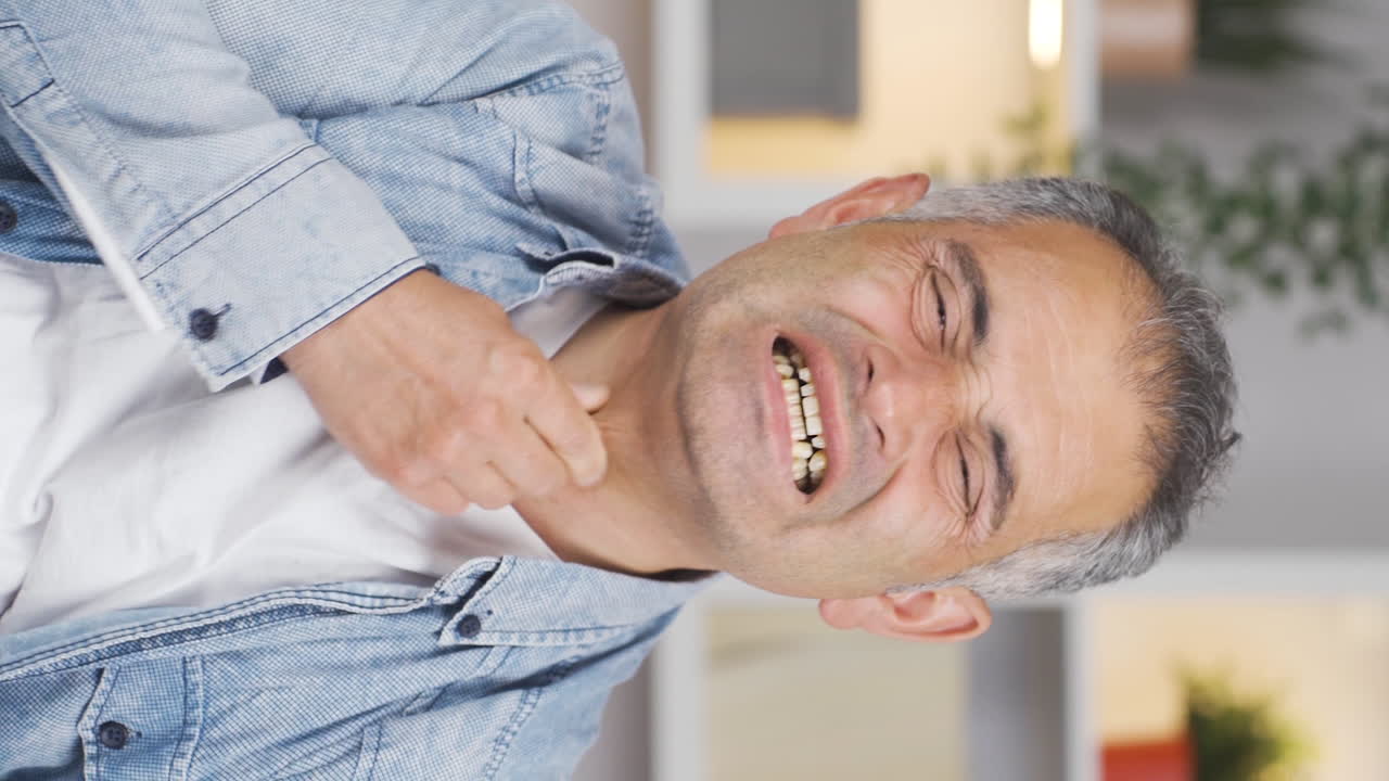 Vertical video of Man with sore throat.