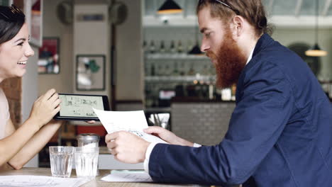 start up business meeting architectural plans in cafe