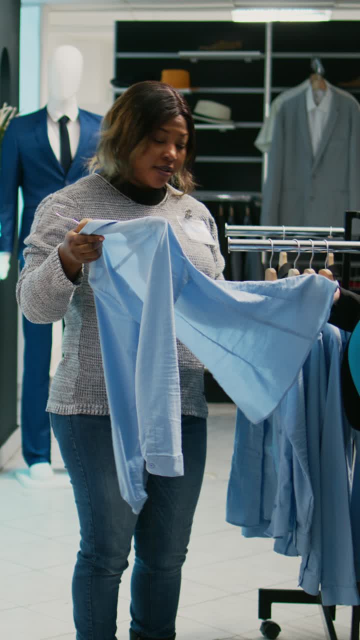 Vertical video: Female client with baby bump shopping for formal wear